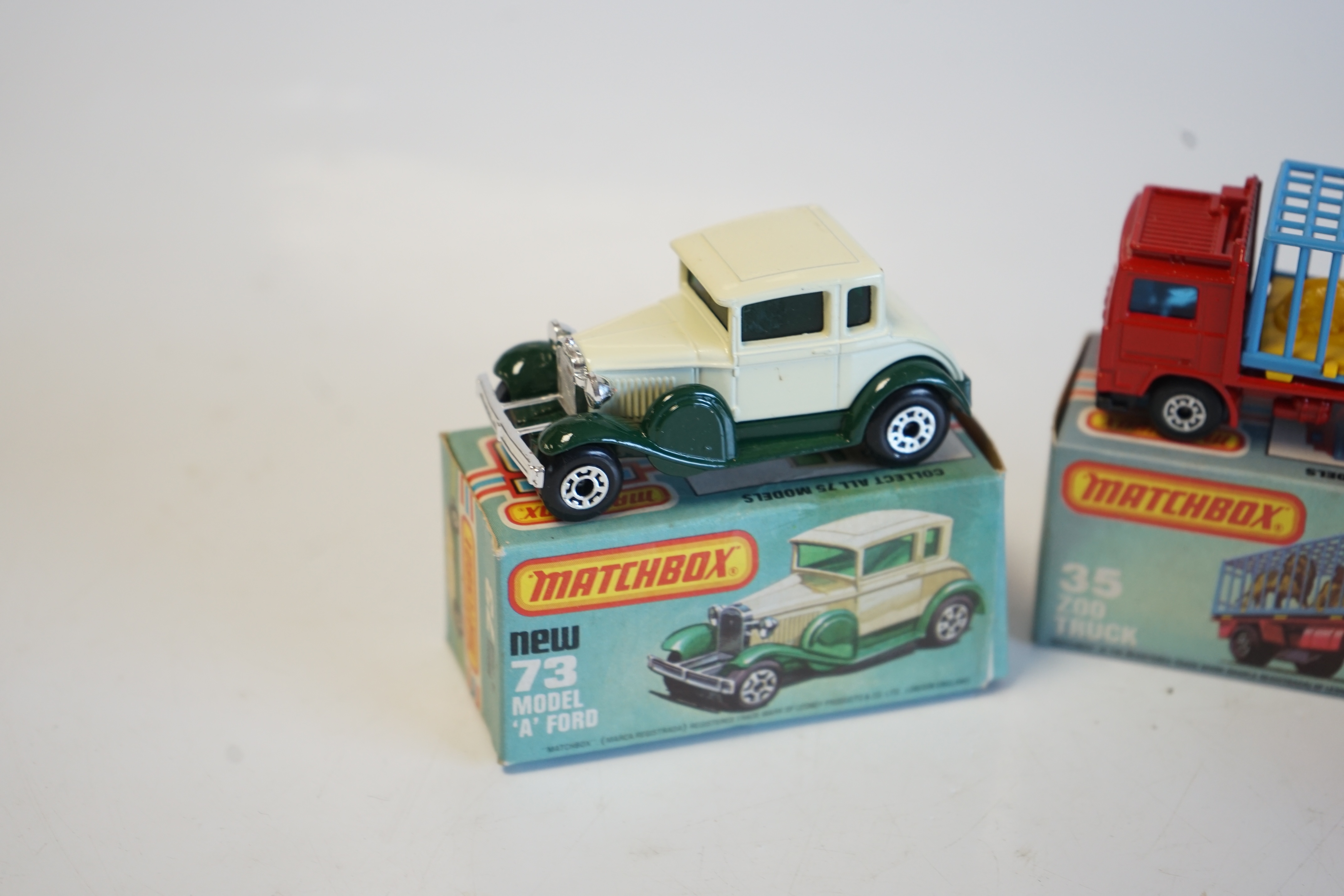 Sixteen boxed Matchbox Series 1-75 diecast vehicles including; 1; Dodge Challenger, 14; Petrol Tanker, 28; Formula Racing Car and another, 34; Chevy Pro Stocker, 35; Zoo Truck and another, 52; Police Launch, 61; Wreck Tr